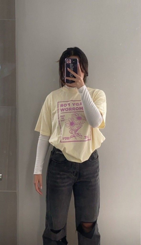 Graphic Tee with Distressed Black Jeans
