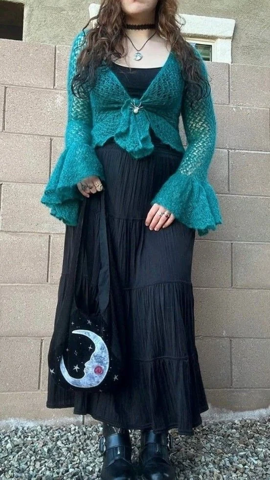 Emerald Cardigan Over Black Pleated Dress
